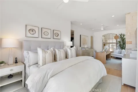 a large bedroom with a bed and a lamp