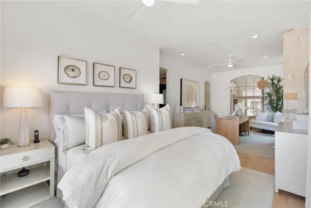 a large bedroom with a bed and a lamp