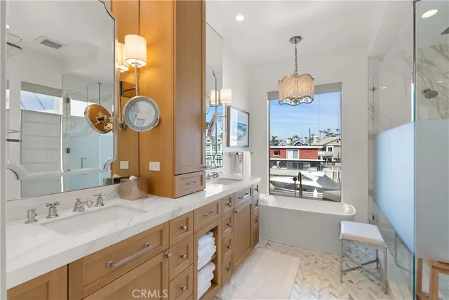 a spacious bathroom with a granite countertop sink a mirror and shower