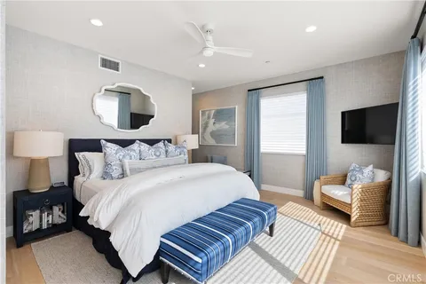 a bedroom with bed and a flat screen tv