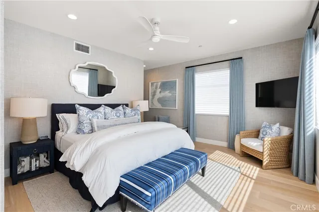 a bedroom with bed and a flat screen tv