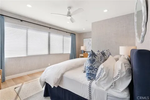 a bedroom with a large bed and a chandelier