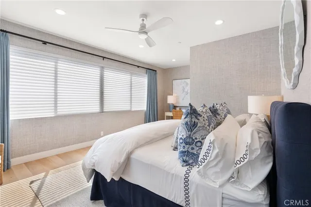 a bedroom with a large bed and a chandelier