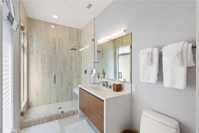 a bathroom with a double vanity sink toilet and shower