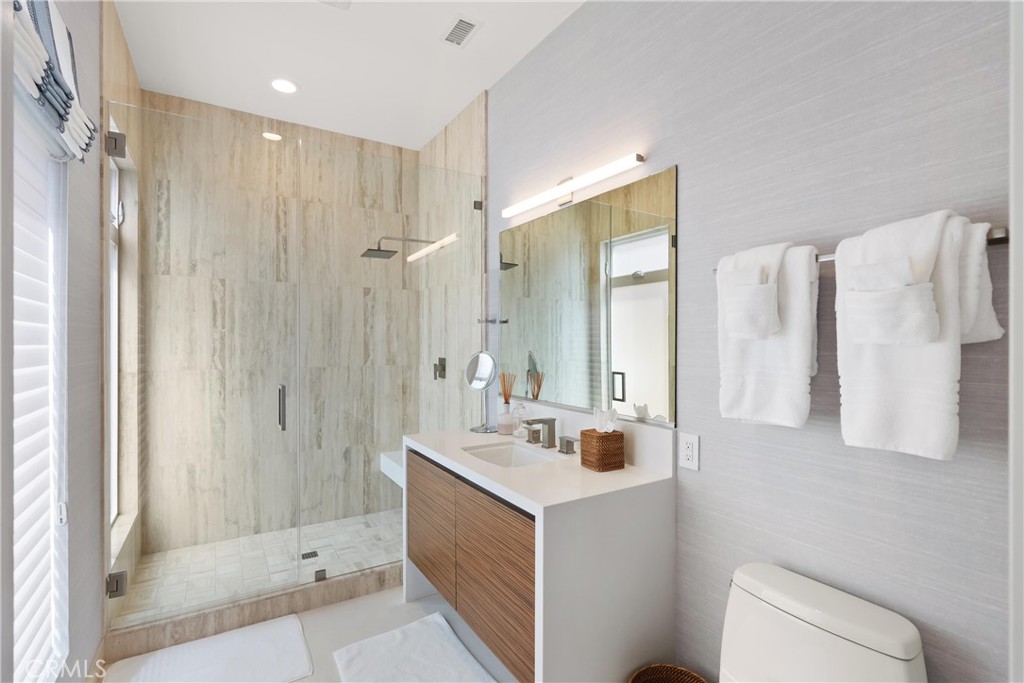 3306 Marcus Avenue Newport Beach, CA 92663 - Photo 24 of 36 a bathroom with a double vanity sink toilet and shower