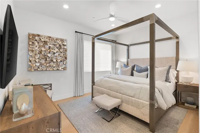 a bedroom with a bed and glass walk in closet