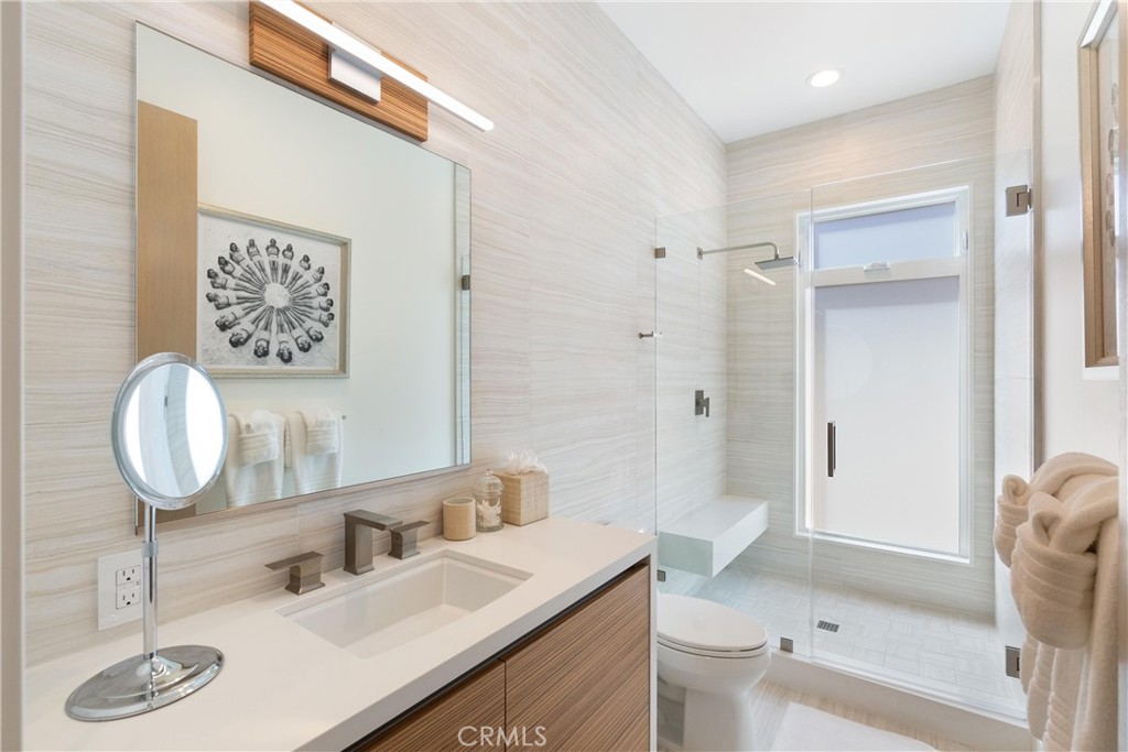 3306 Marcus Avenue Newport Beach, CA 92663 - Photo 27 of 36 a bathroom with a sink a toilet and a mirror
