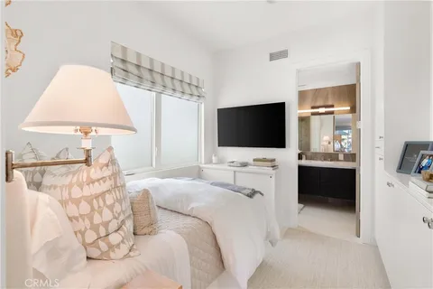 a hotel room with a bed tv and a window