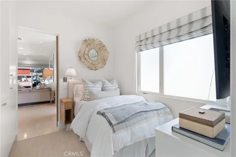 a bedroom with a bed couch and a window