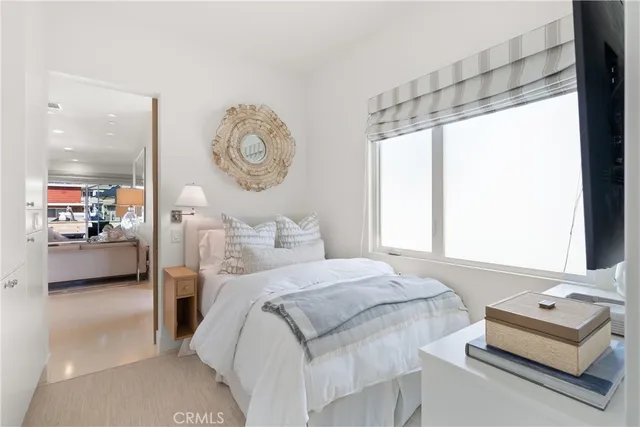 a bedroom with a bed couch and a window