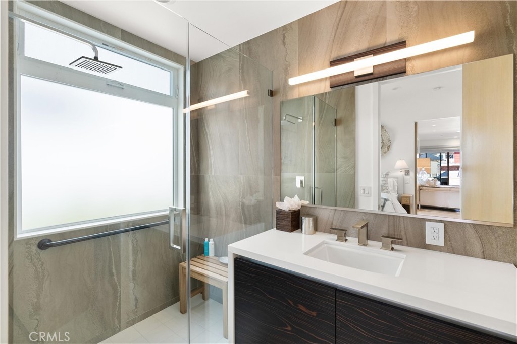 3306 Marcus Avenue Newport Beach, CA 92663 - Photo 30 of 36 a bathroom with a double vanity sink and mirror