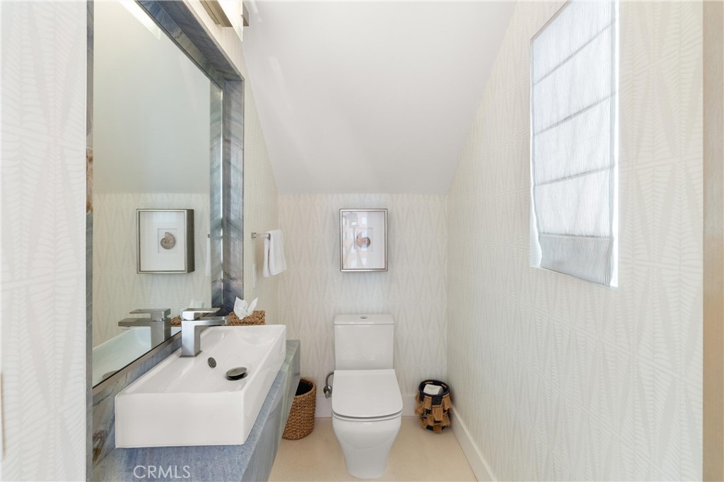 3306 Marcus Avenue Newport Beach, CA 92663 - Photo 31 of 36 a bathroom with a sink toilet and a mirror