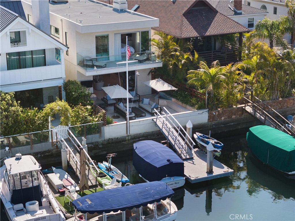 3306 Marcus Avenue Newport Beach, CA 92663 - Photo 35 of 36 a view of a patio with couches table and chairs under an umbrella