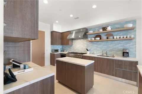 a kitchen that has a sink and a stove in it