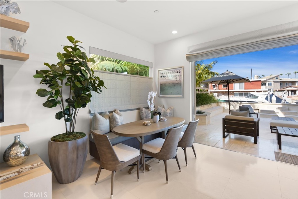 3306 Marcus Avenue Newport Beach, CA 92663 - Photo 8 of 36 a dining room with furniture potted plants and wooden floor