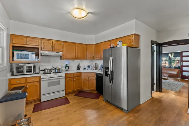 a kitchen with stainless steel appliances granite countertop a refrigerator and a stove top oven