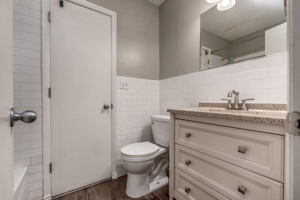 3501 Roswell Road Northeast, Unit 103 Atlanta, GA 30305 - Photo 11 of 13 a bathroom with a sink a toilet and shower