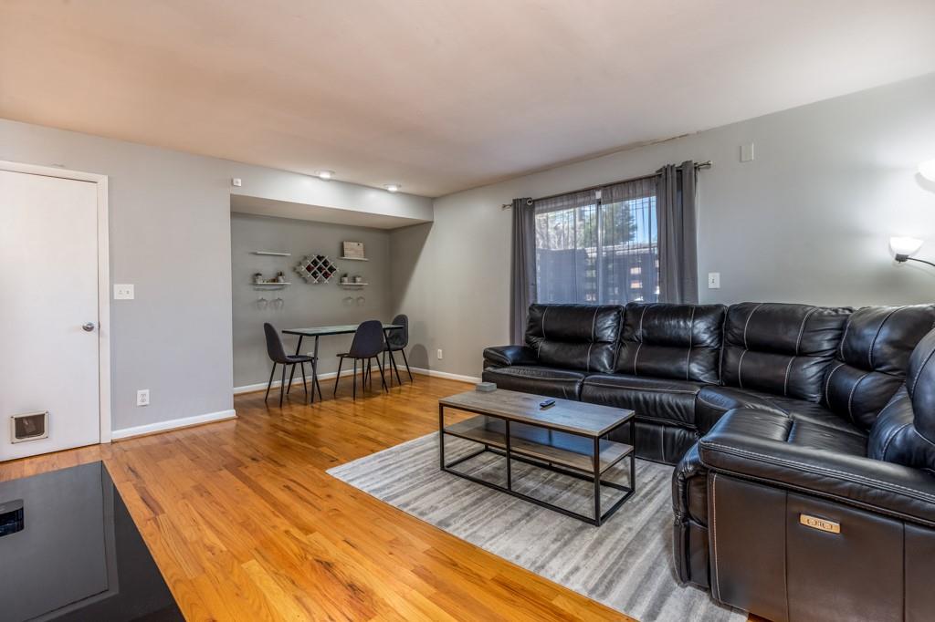 3501 Roswell Road Northeast, Unit 103 Atlanta, GA 30305 - Photo 2 of 13 a living room with furniture a rug and a window