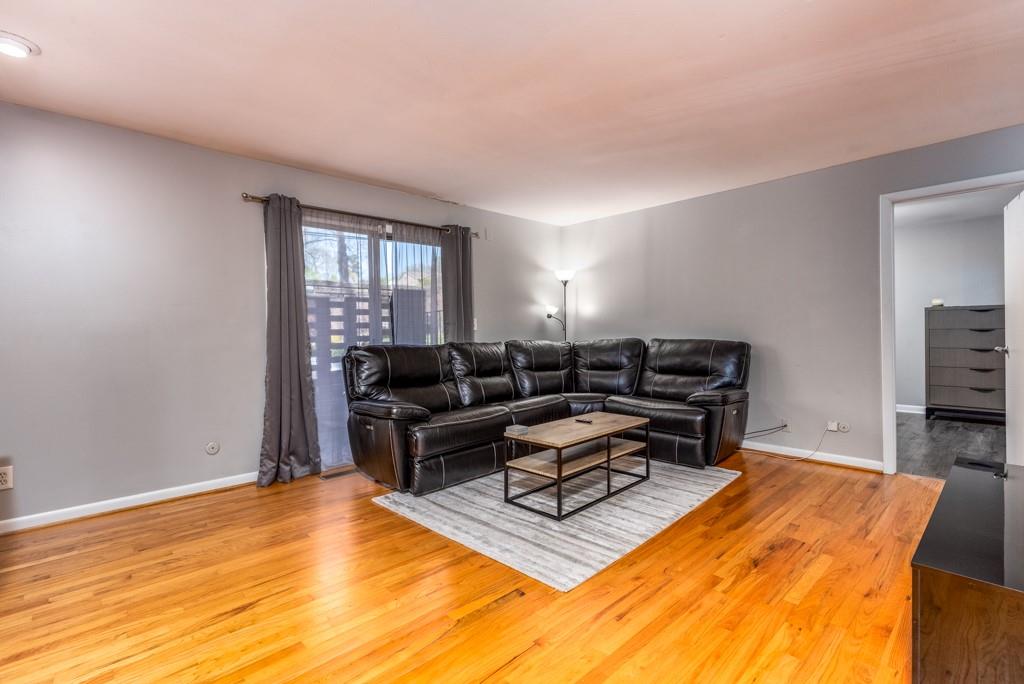 3501 Roswell Road Northeast, Unit 103 Atlanta, GA 30305 - Photo 3 of 13 a living room with furniture and a flat screen tv