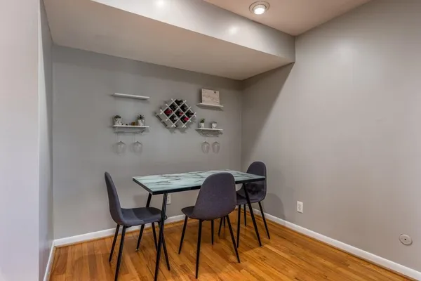 a view of a workspace with furniture and wooden floor