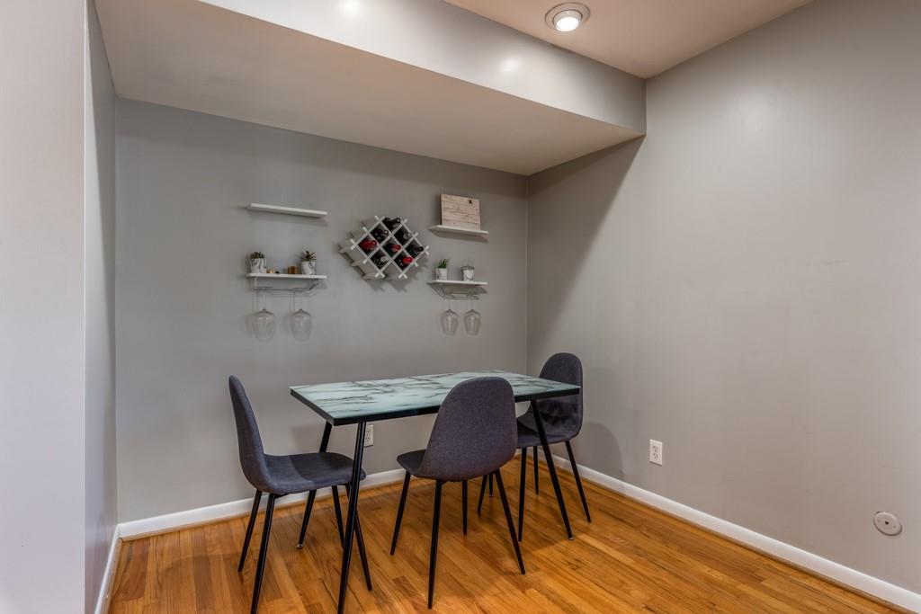 3501 Roswell Road Northeast, Unit 103 Atlanta, GA 30305 - Photo 5 of 13 a view of a workspace with furniture and wooden floor