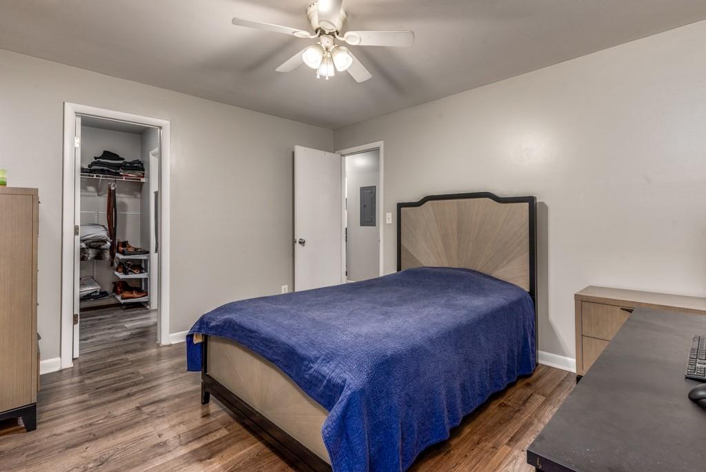 3501 Roswell Road Northeast, Unit 103 Atlanta, GA 30305 - Photo 9 of 13 a bedroom with a bed and a chandelier