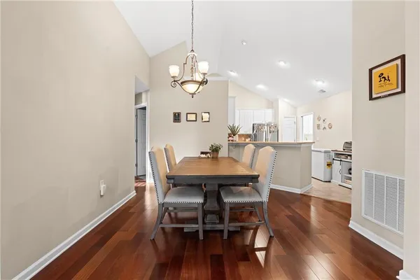 a view of a dining room with furniture and wooden floor