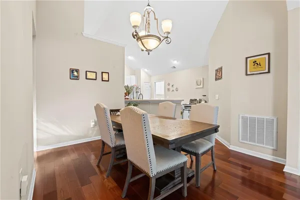 a view of a dining room with furniture wooden floor and chandelier