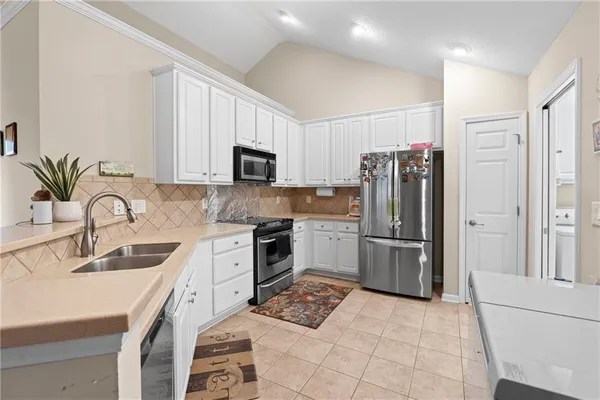 a kitchen with a sink stove and refrigerator