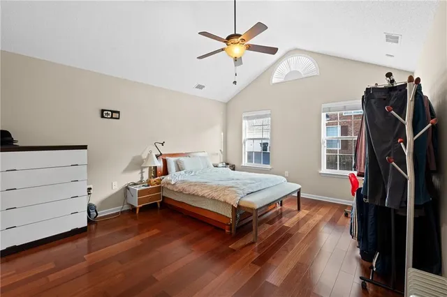 a bedroom with a bed and a ceiling fan