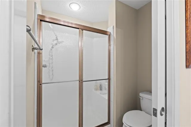 a bathroom with a toilet and a shower