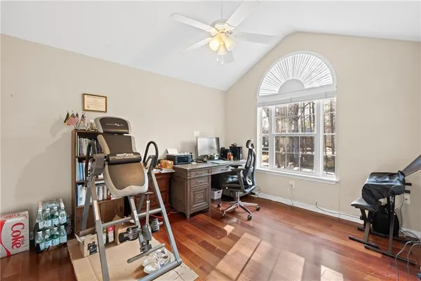 a view of a workspace with furniture and a window