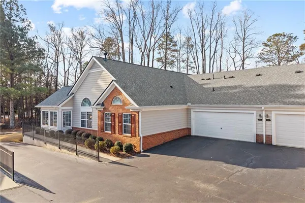 a view of a house with a yard covered in snow
