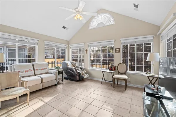 a living room with furniture and a floor to ceiling window