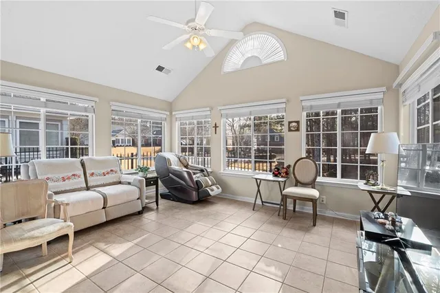 a living room with furniture and a floor to ceiling window