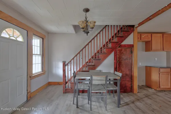 a hallway with granite countertop a sink a stove a window and a refrigerator