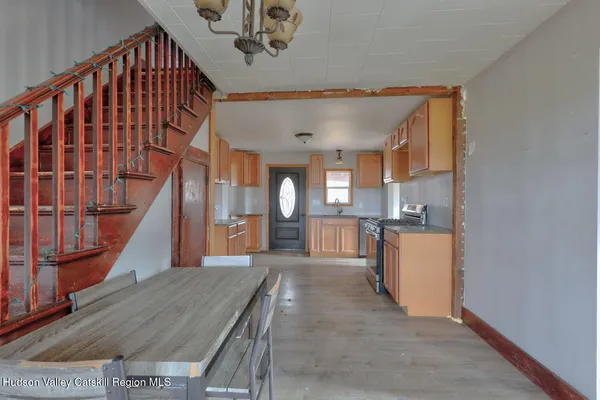 a kitchen with stainless steel appliances granite countertop a stove a microwave and a refrigerator