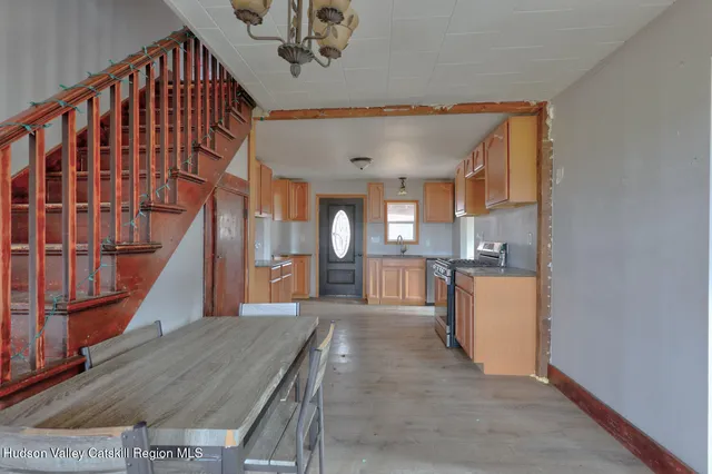 a kitchen with stainless steel appliances granite countertop a stove a microwave and a refrigerator