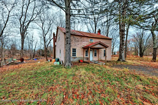 a view of a house with a yard and sitting area