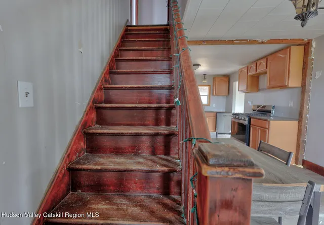 a view of empty room with wooden floor and window