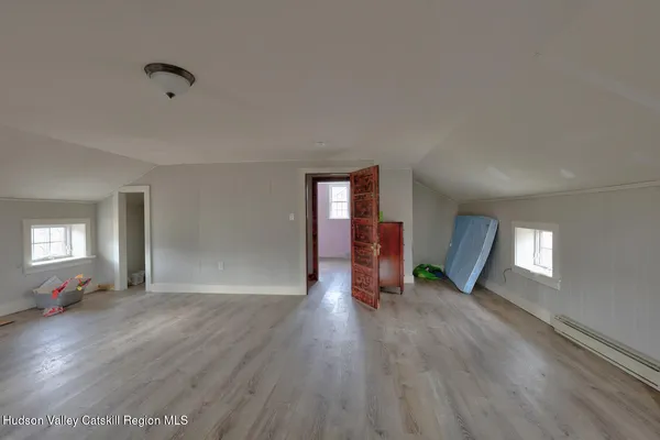 an empty room with windows and closet