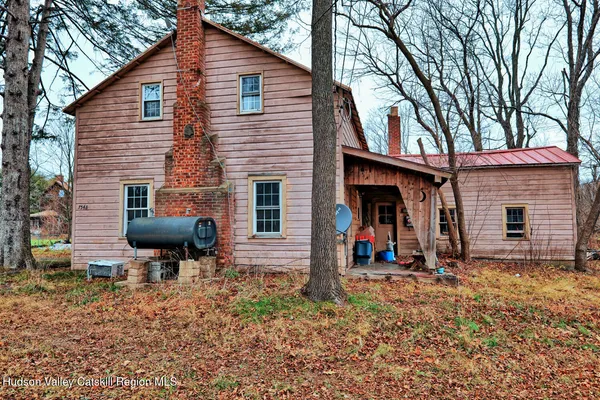 a backyard of a house with barbeque oven