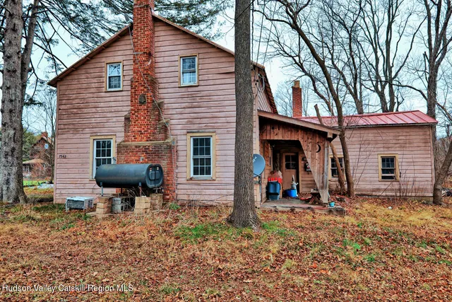 a backyard of a house with barbeque oven