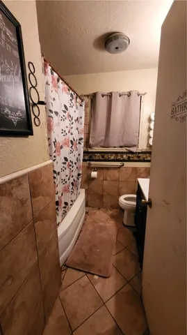 a view of backyard with swimming pool and sitting area