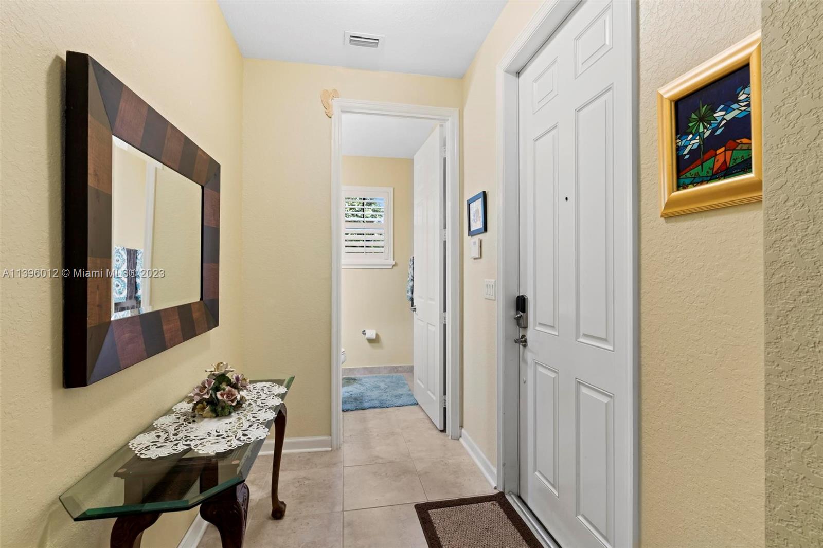 12120 Village Place Davie, FL 33325 - Photo 3 of 35 a living room with furniture and paintings on the wall