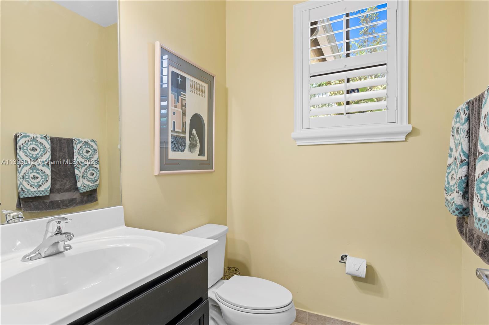 12120 Village Place Davie, FL 33325 - Photo 4 of 35 a bathroom with a sink mirror vanity and toilet