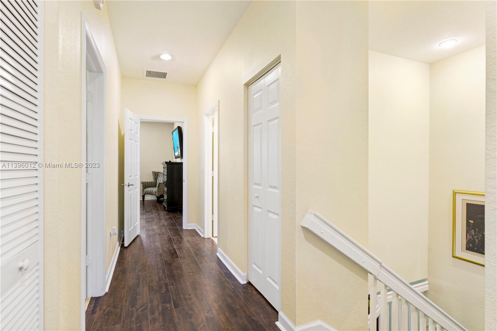 12120 Village Place Davie, FL 33325 - Photo 9 of 35 a view of a hallway with a hardwood floor