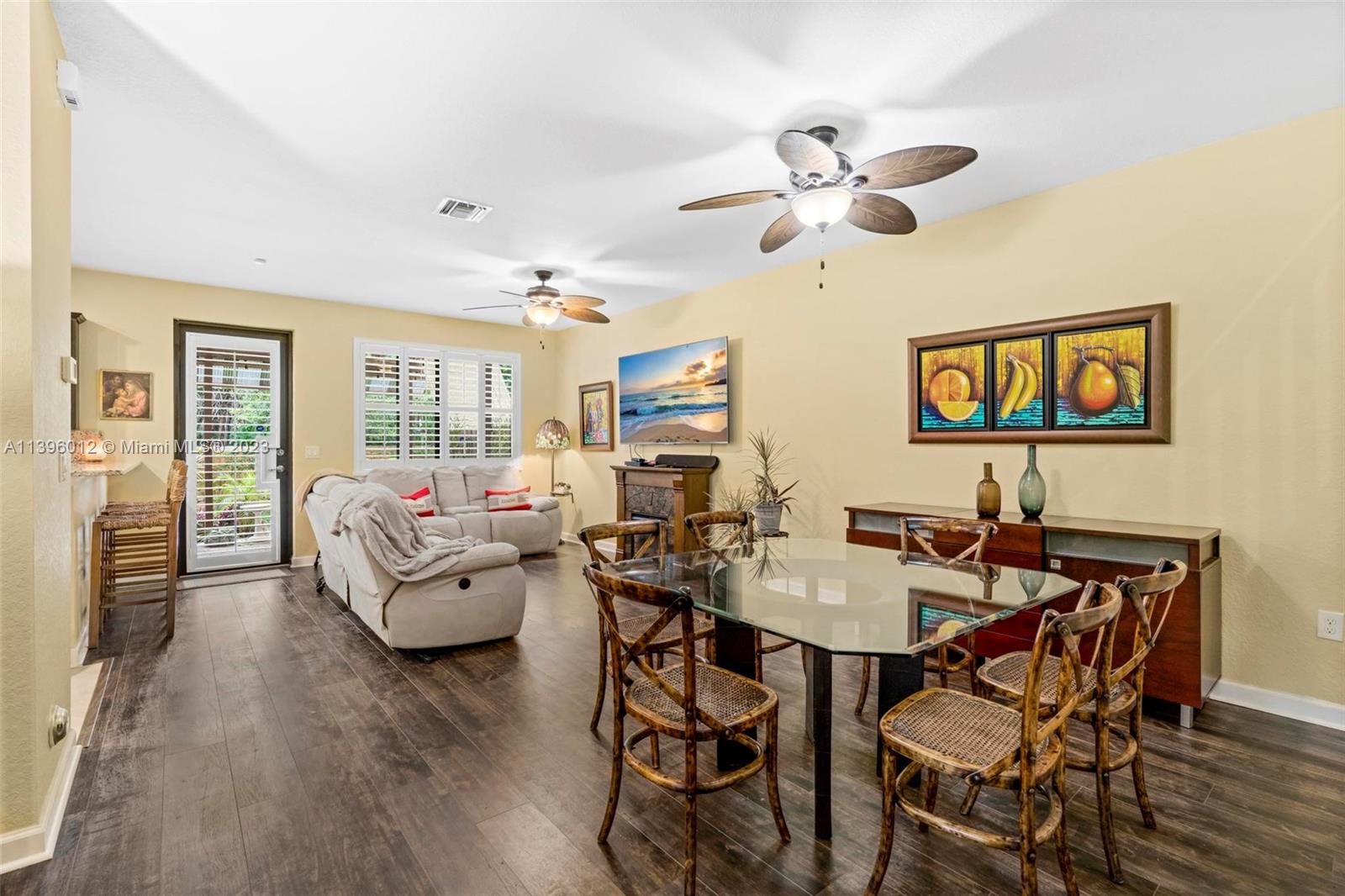 12120 Village Place Davie, FL 33325 - Photo 10 of 35 a view of a dining room with furniture and wooden floor