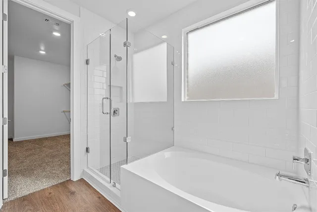 a bathroom with a bathtub and a shower