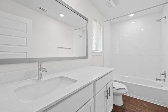 a bathroom with a sink a toilet and vanity